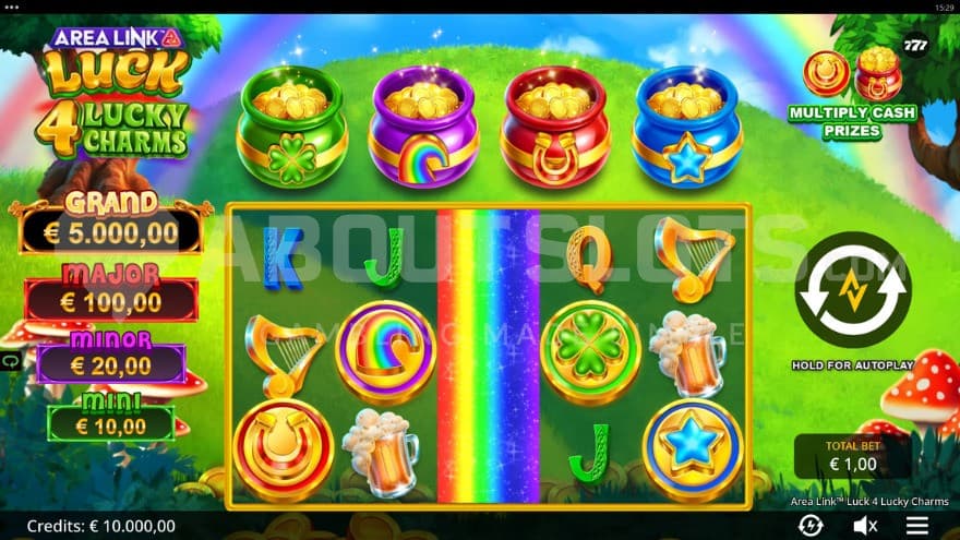 Four pot of gold sit atop of the reels on a green hill with a rainbow in the background