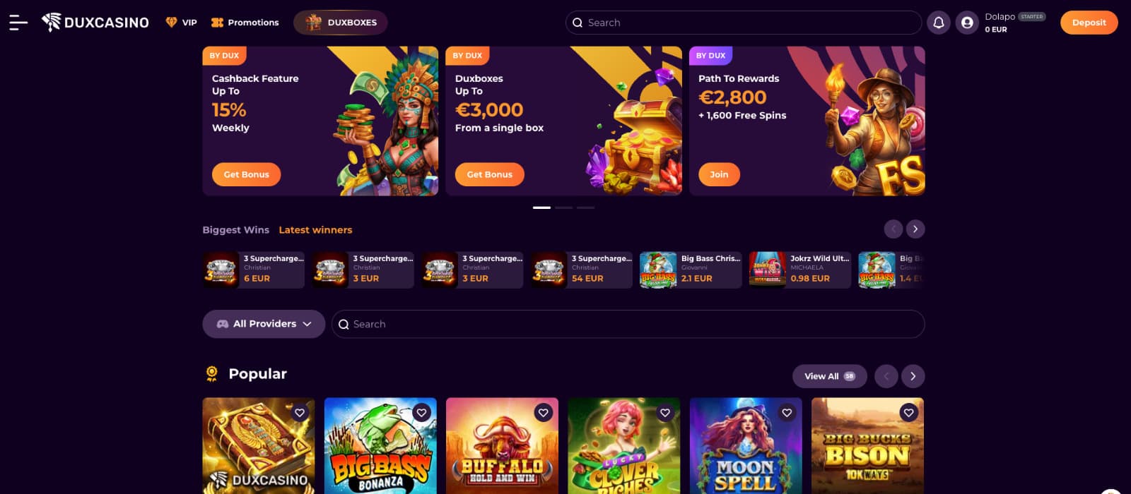DuxCasino homepage showing cashback promotions, Duxboxes rewards, latest winners, provider filter, and featured slot games.