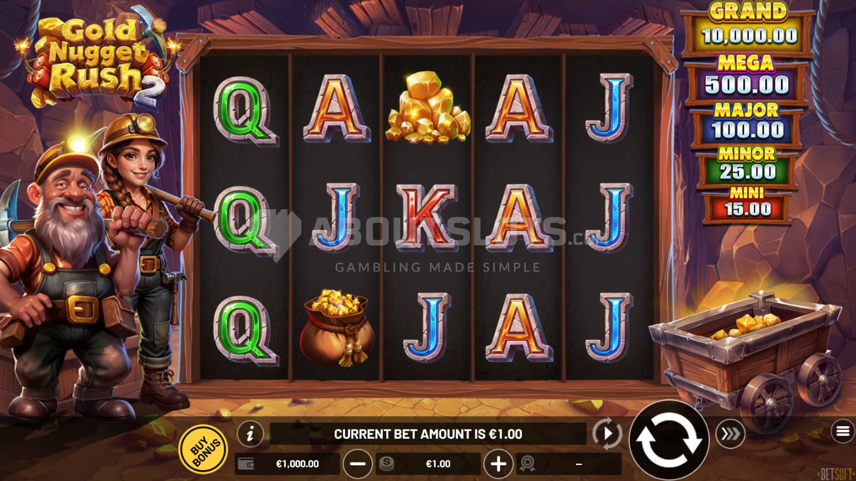 The two gold miners stand next to the playing grid, hardhat on and pickaxe at the ready