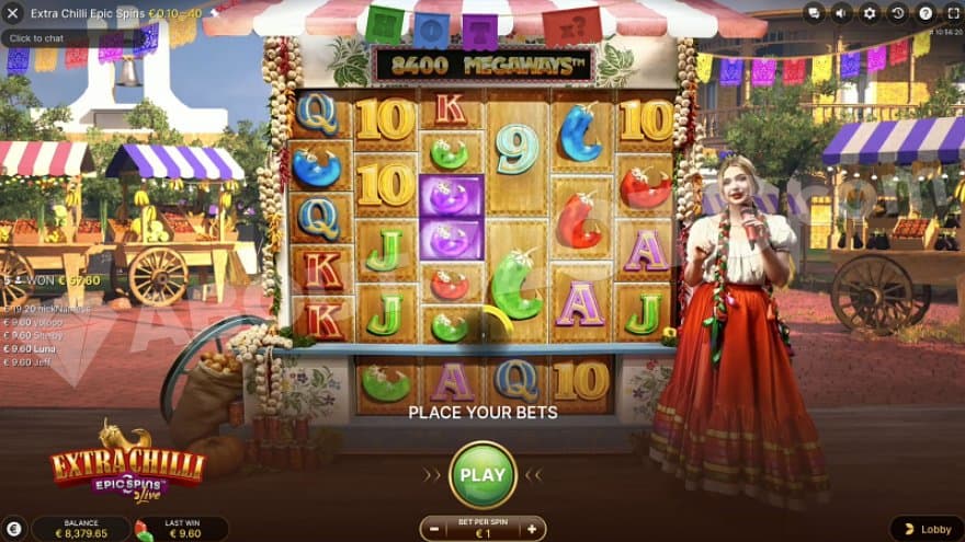 A Mexican fruit market with the casino slot in the middle on a stall and a host in front of it.