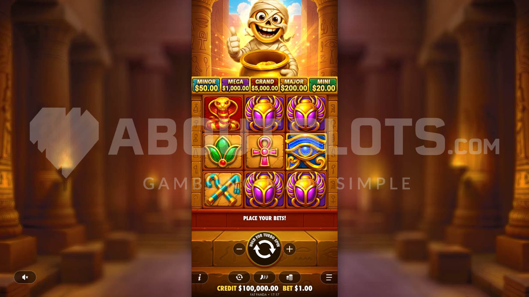 Tut stands ontop of the playing grid with a pot of gold in hand