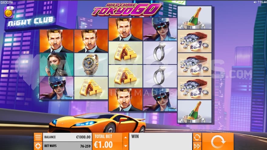 A luxurious car speeding down the street past high-rise towers in the background