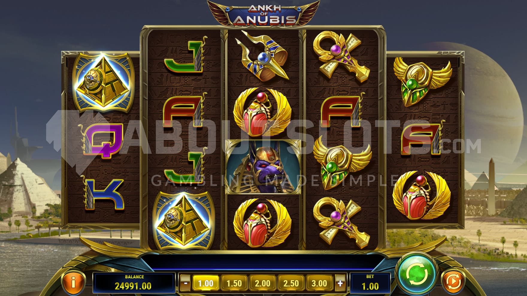 Base Game view of a 5-reel grid on a backdrop of an Egyptian landscape.