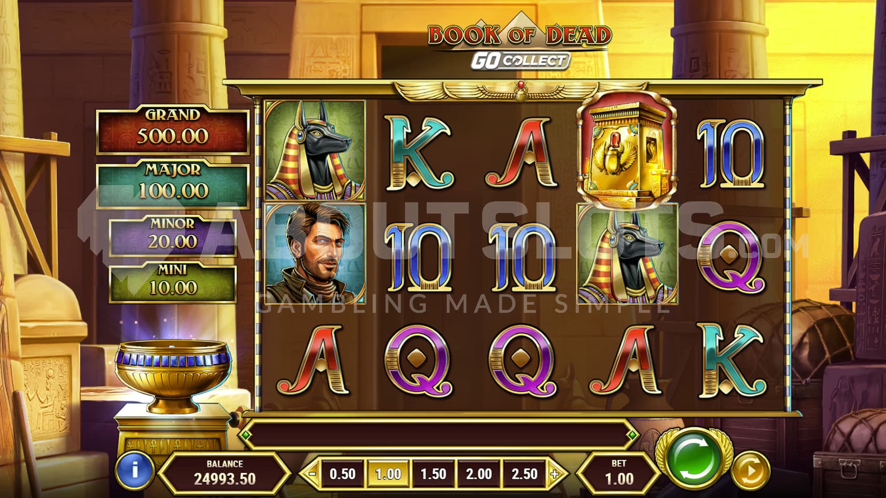 Base Game view of a 5x3 grid set on a backdrop of an entrance to an Egyptian pyramid.