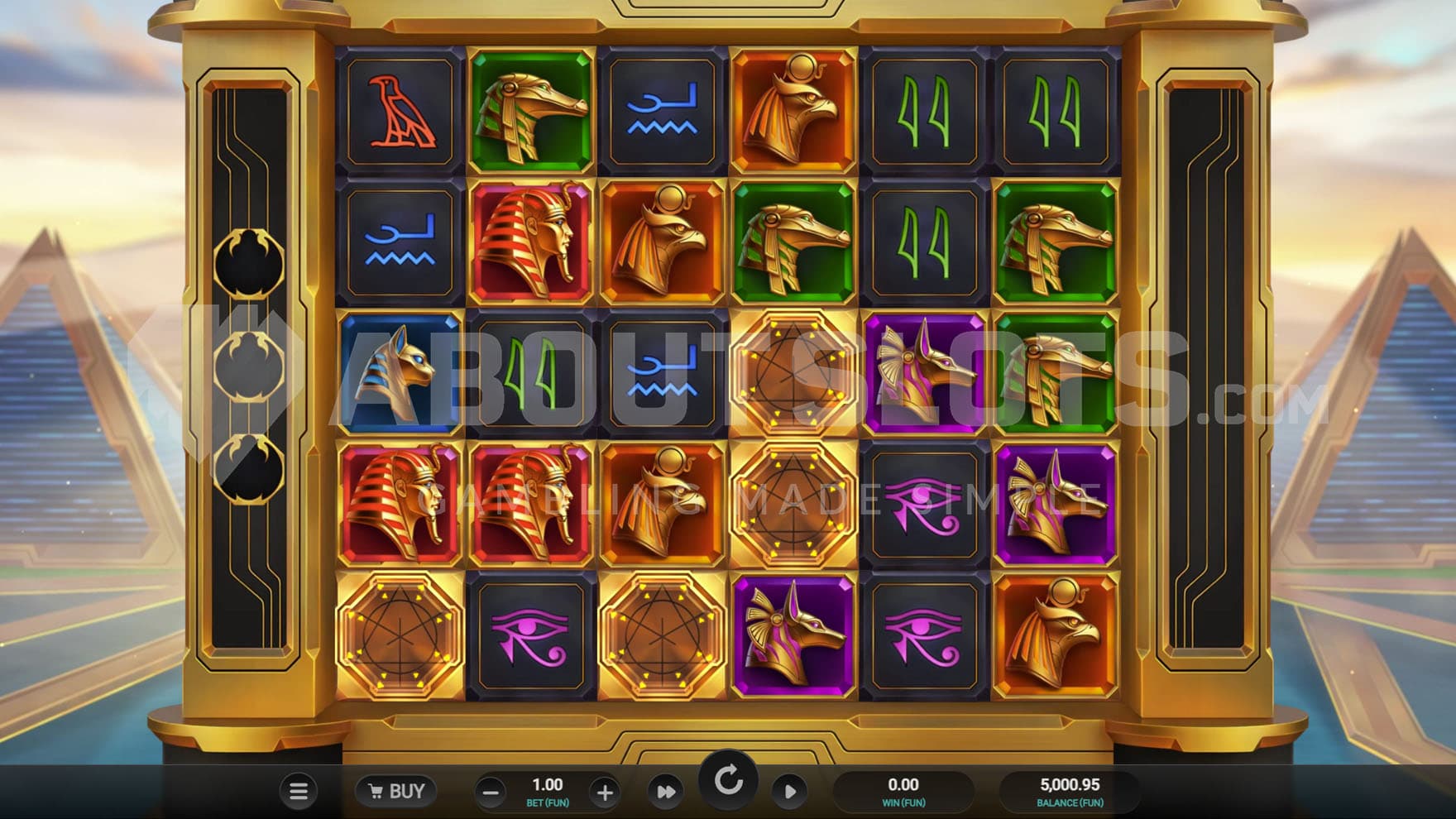 Base game view of a 6x5 grid on a golden frame on a backdrop of a desert landscape with two pyramids on the sides.