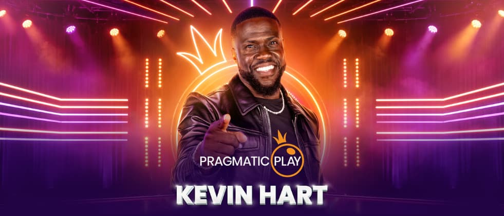 Kevin Hart standing in the middle, smiling and pointing towards the viewer.